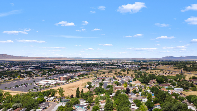 2875 North 400 West, Unit 7 Layton, UT 84041 - Photo 27 of 29 Expansive aerial perspective showcasing a broad urban landscape with residential and commercial areas, surrounded by distant mountains