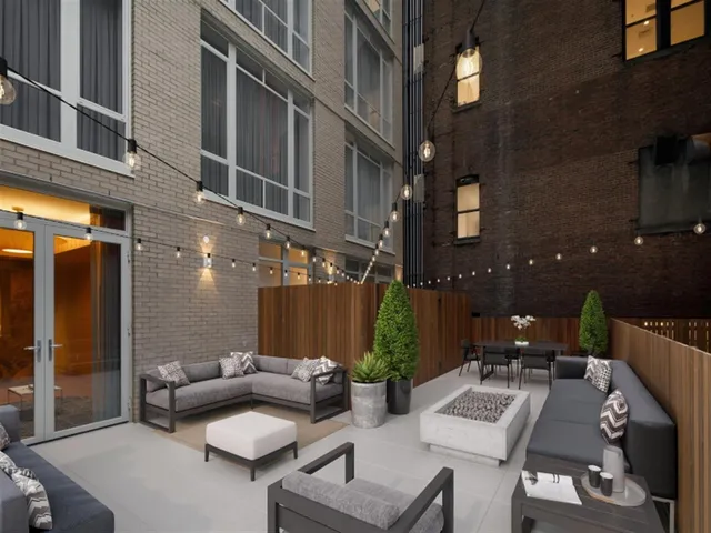 a view of a patio with couches table and chairs with plants