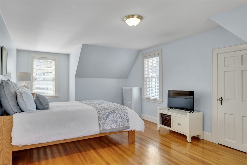 90 Governors Road Milton, MA 02186 - Photo 14 of 28 a bedroom with a bed and a flat screen tv