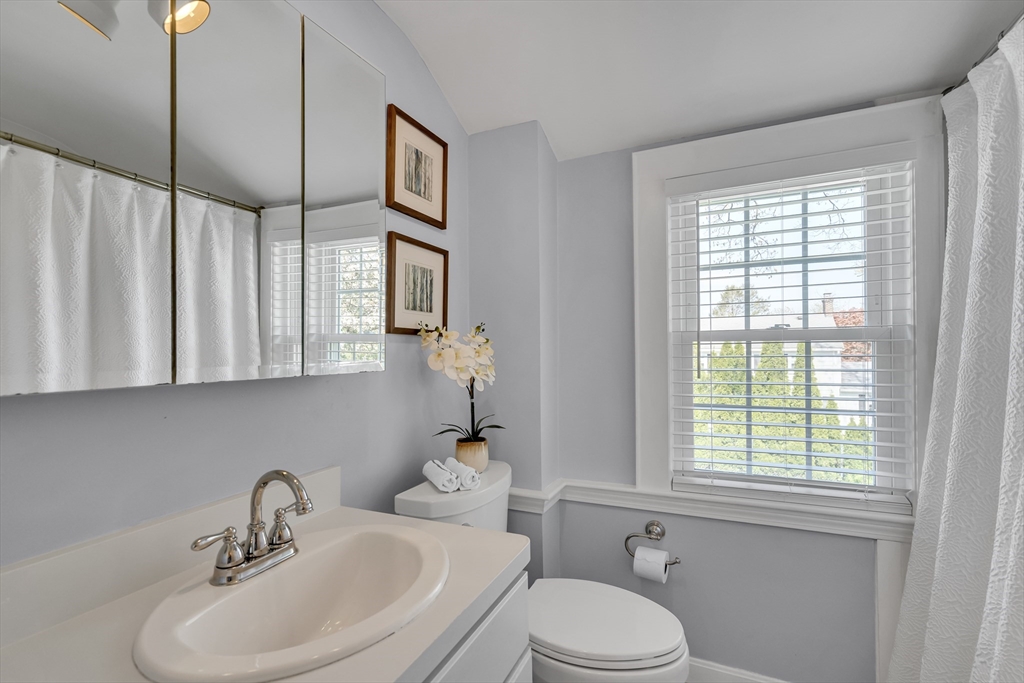 90 Governors Road Milton, MA 02186 - Photo 15 of 28 a bathroom with a sink a toilet and a window