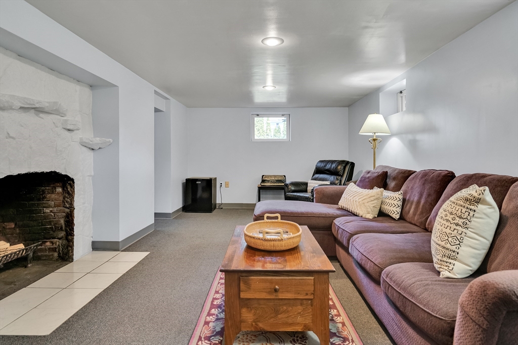 90 Governors Road Milton, MA 02186 - Photo 19 of 28 a living room with furniture a fireplace and a fireplace
