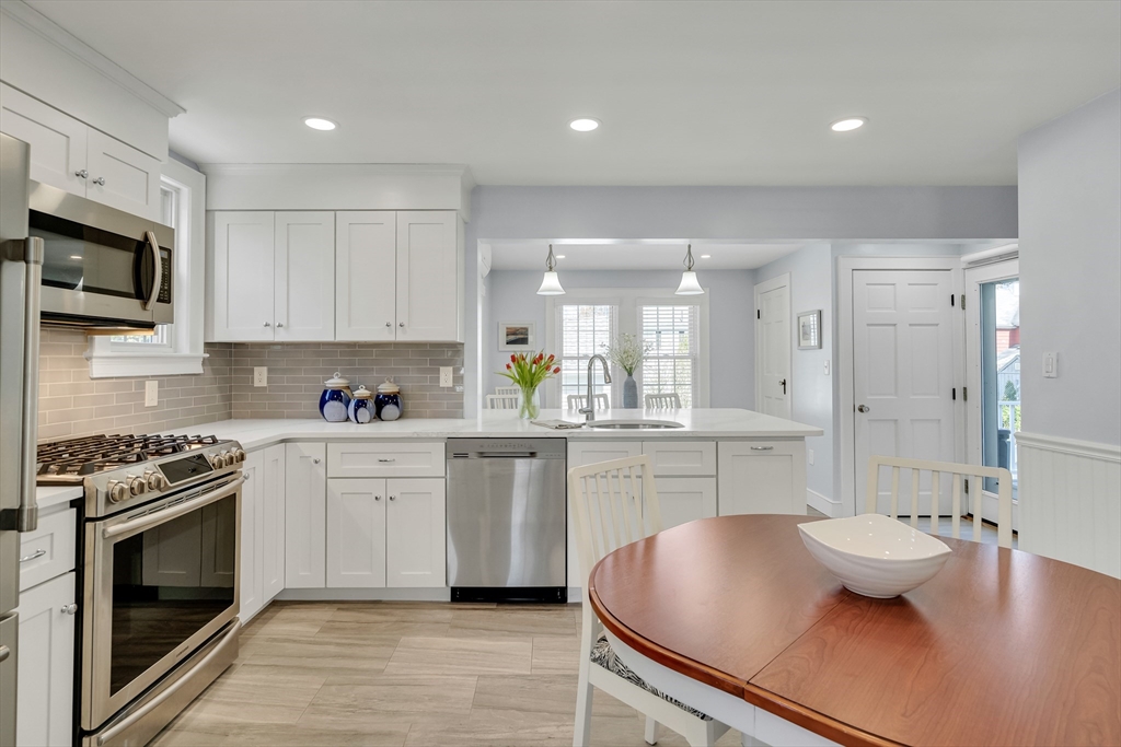 90 Governors Road Milton, MA 02186 - Photo 4 of 28 a kitchen with a sink stove and white cabinets