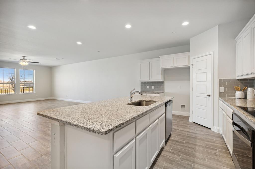 6028 Bursey Road Watauga, TX 76148 - Photo 10 of 27 a kitchen with stainless steel appliances granite countertop a sink stove and cabinets