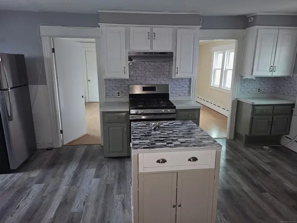 a kitchen with wooden floors and a stove top oven