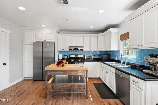a kitchen with a sink stove and refrigerator
