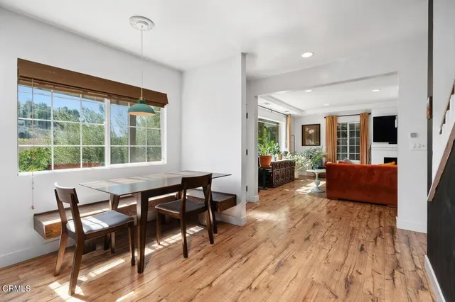 a living room with furniture a flat screen tv and a large window