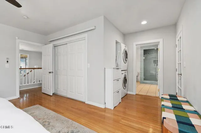 a view of a hallway with wooden floor and cabinet
