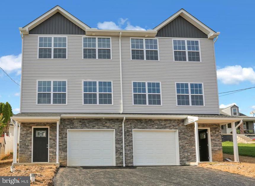 a front view of a house with large windows
