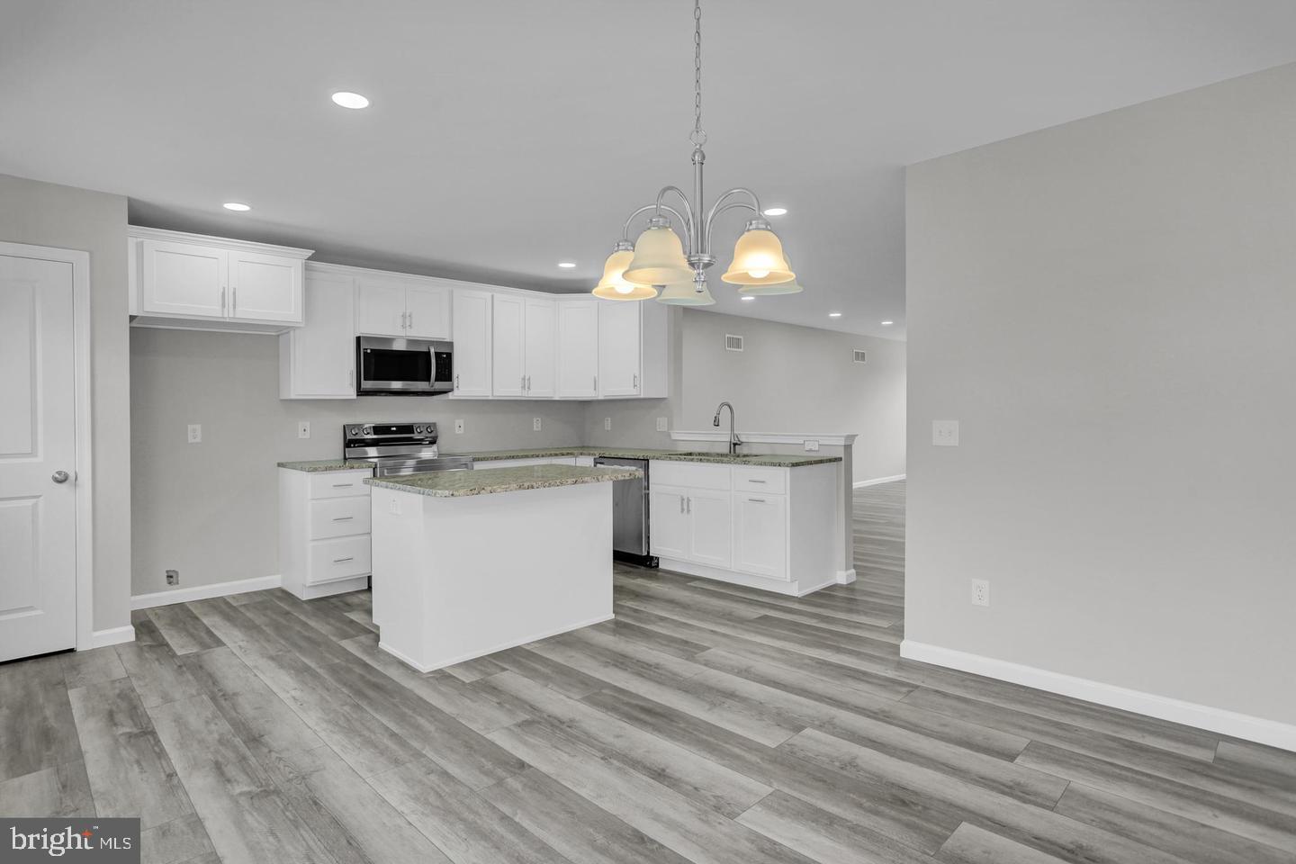 46 Rosalie's Way Temple, PA 19560 - Photo 4 of 12 a view of kitchen with microwave stove refrigerator and cabinets