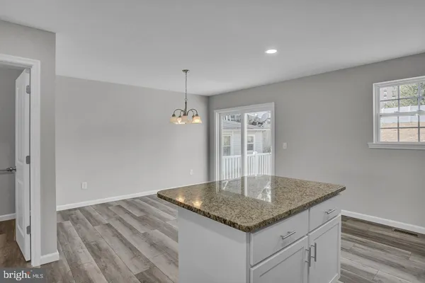 a kitchen with stainless steel appliances granite countertop a sink window and refrigerator