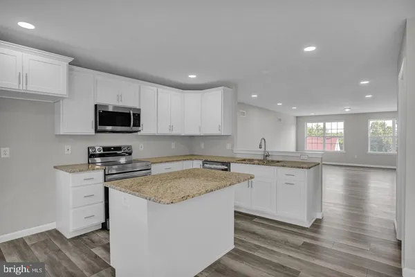 a kitchen with a sink stove and microwave