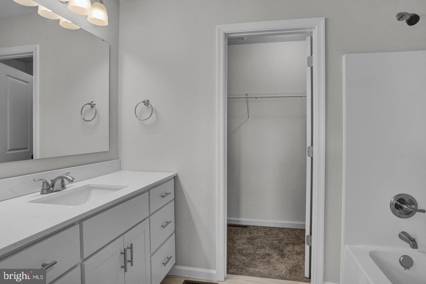 46 Rosalie's Way Temple, PA 19560 - Photo 9 of 12 a bathroom with a granite countertop sink a mirror and a shower