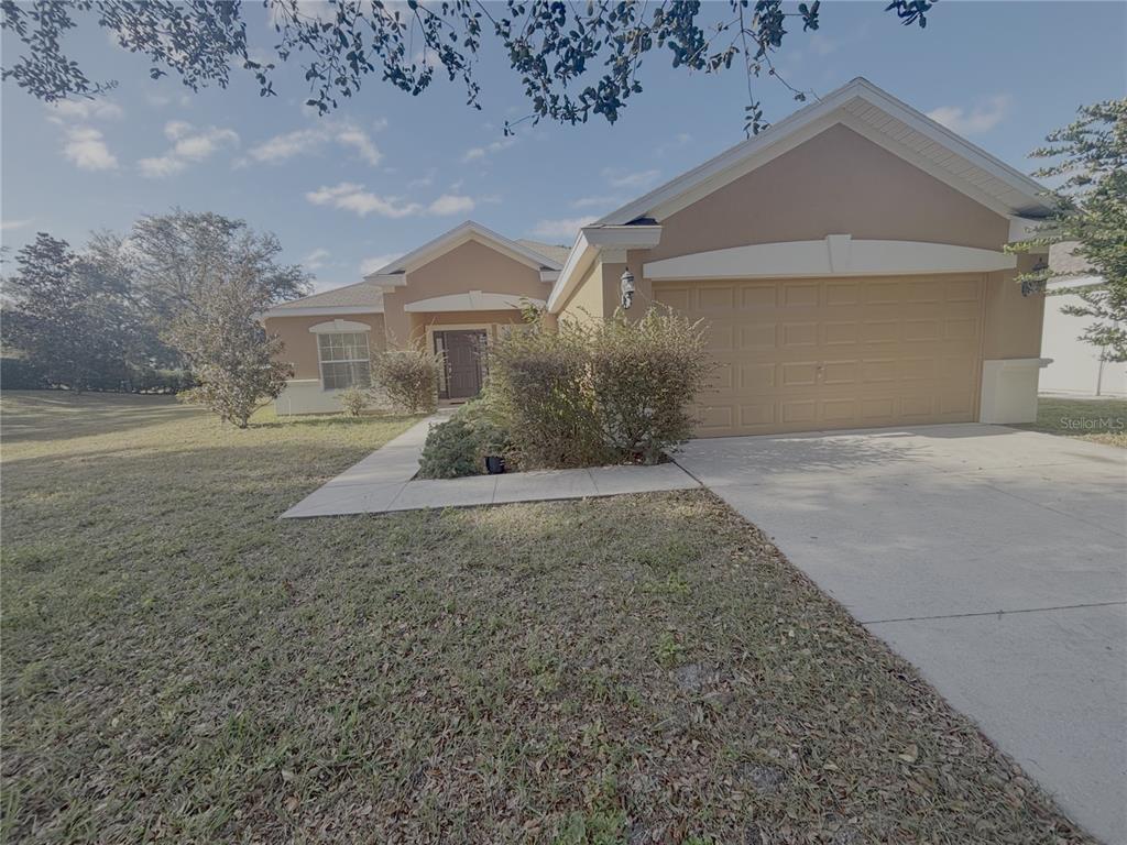 4194 Southwest 47th Court Ocala, FL 34474 - Photo 1 of 29 a front view of a house with a yard and garage