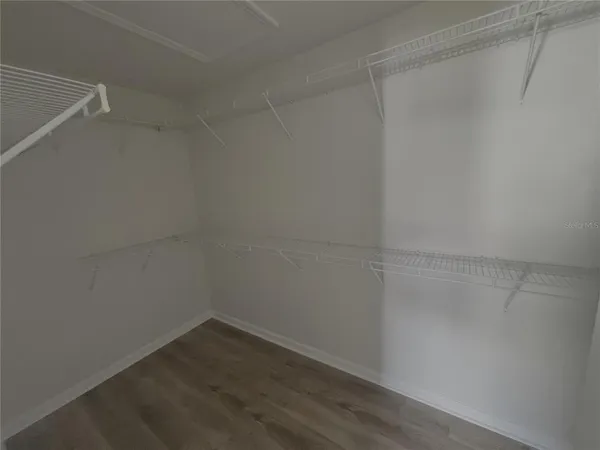 a empty closet with wooden floor