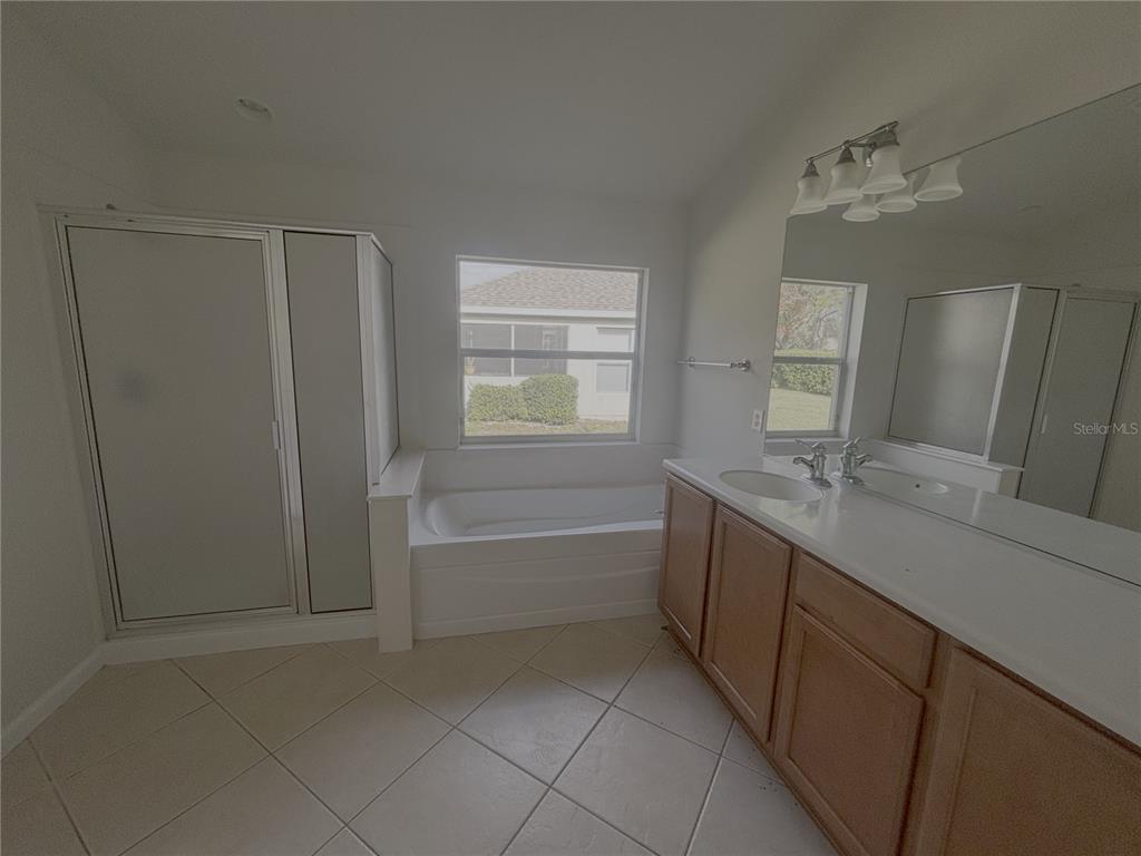 4194 Southwest 47th Court Ocala, FL 34474 - Photo 12 of 29 a bathroom with a sink a vanity and mirror