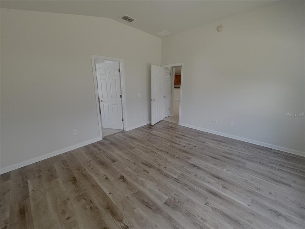 4194 Southwest 47th Court Ocala, FL 34474 - Photo 14 of 29 a view of an empty room with wooden floor