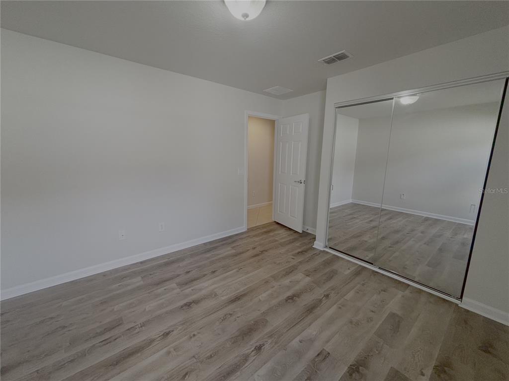 4194 Southwest 47th Court Ocala, FL 34474 - Photo 15 of 29 a view of an empty room with wooden floor and a window
