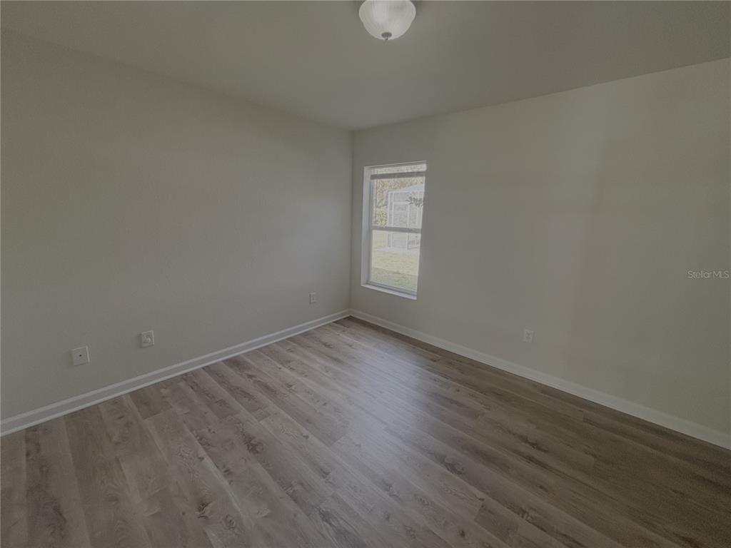 4194 Southwest 47th Court Ocala, FL 34474 - Photo 18 of 29 a view of an empty room and wooden floor