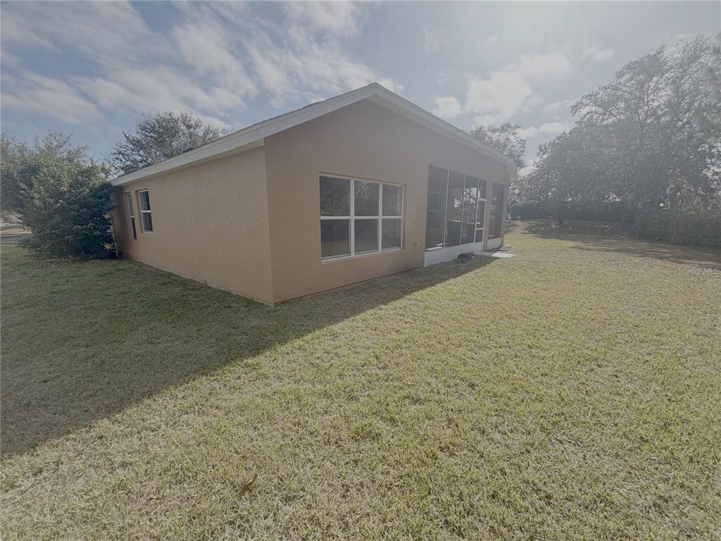 4194 Southwest 47th Court Ocala, FL 34474 - Photo 28 of 29 a view of house with backyard and garden
