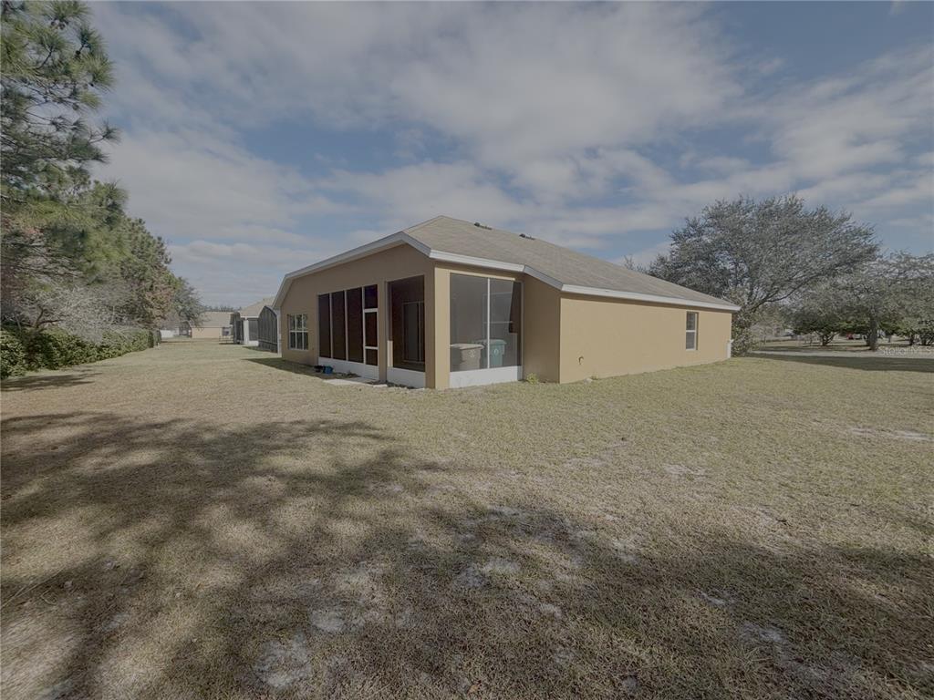 4194 Southwest 47th Court Ocala, FL 34474 - Photo 29 of 29 a front view of house with yard and trees in the background