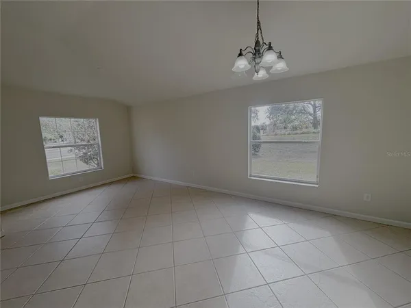 a view of a room with an empty space and a window