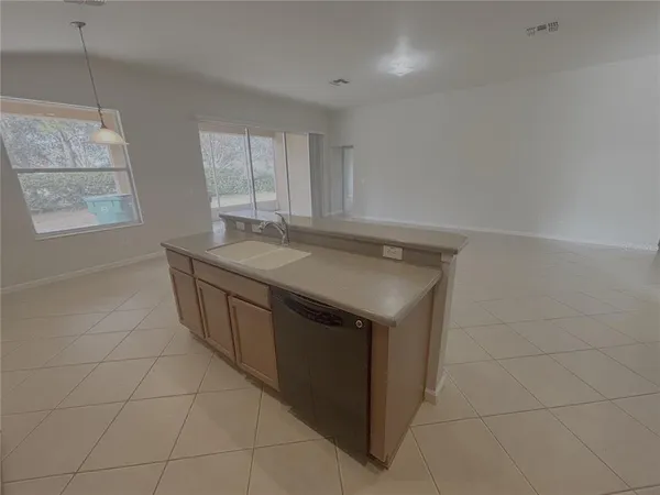 a utility room with a sink a vanity and window