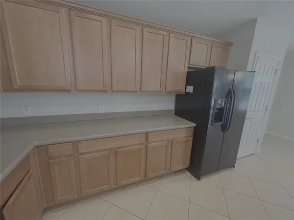 a kitchen with stainless steel appliances a refrigerator and cabinets
