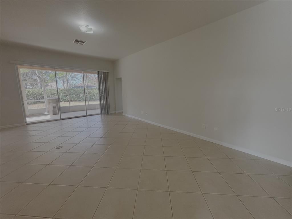 4194 Southwest 47th Court Ocala, FL 34474 - Photo 10 of 29 an empty room with wooden floor and windows
