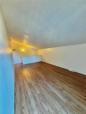 a view of balcony with wooden floor