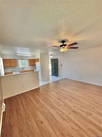 a view of a kitchen with a sink and a refrigerator