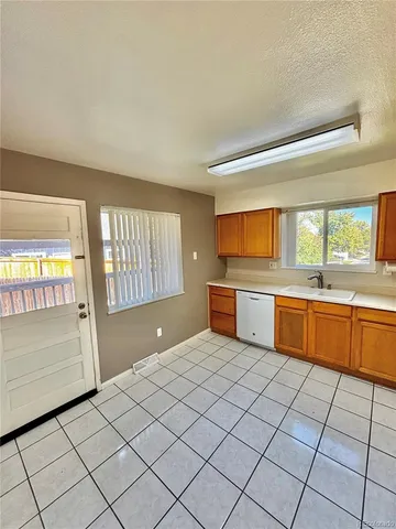a kitchen with stainless steel appliances a sink and a large window