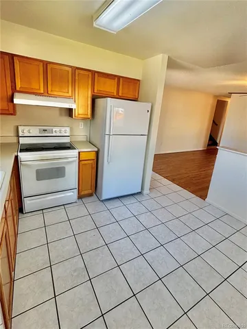 a kitchen with a refrigerator sink and stove