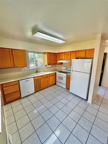 a kitchen with stainless steel appliances granite countertop a refrigerator sink and cabinets