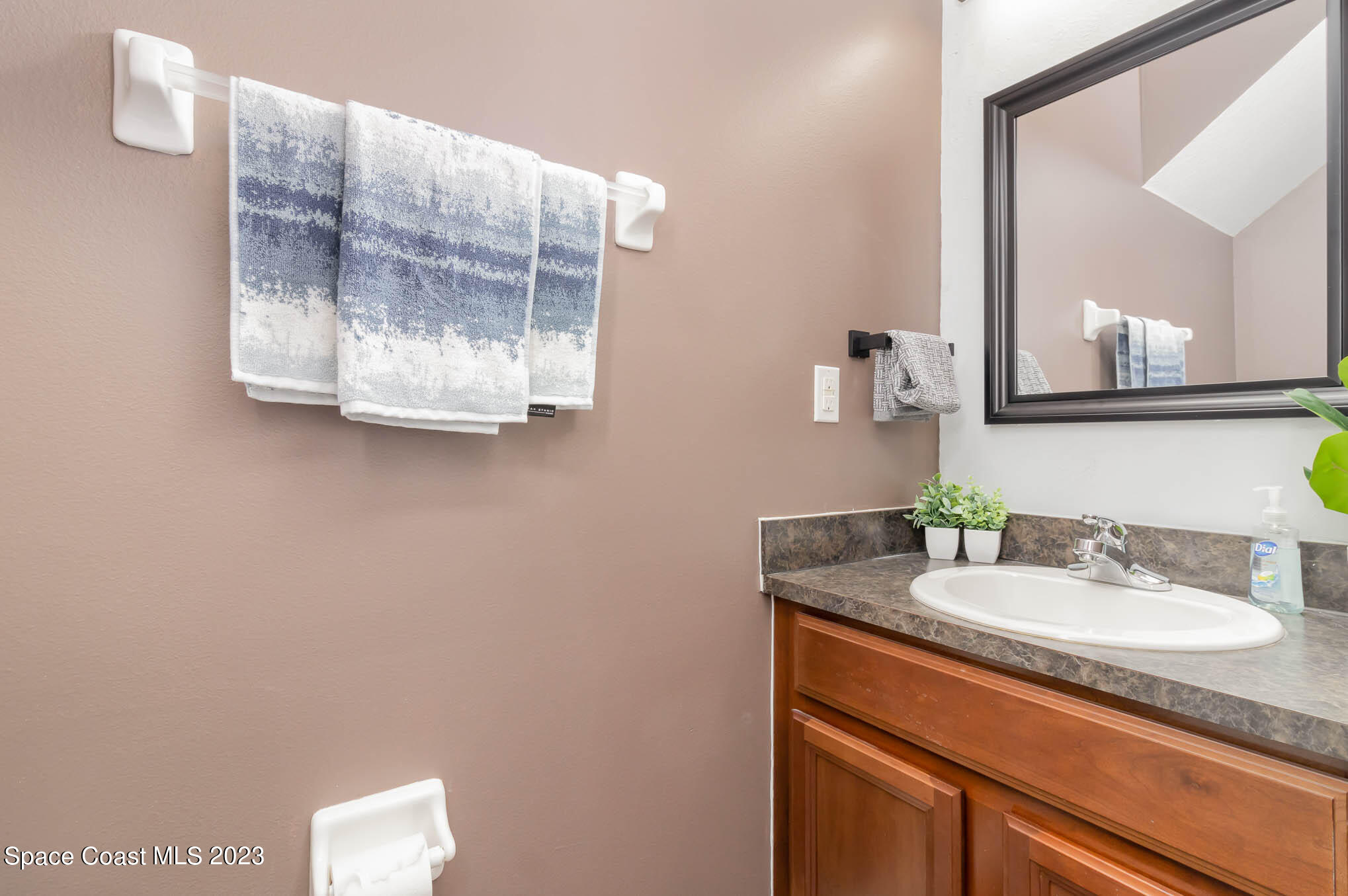 2805 Reston Street, Unit 103 Melbourne, FL 32935 - Photo 14 of 36 a bathroom with a sink and a mirror