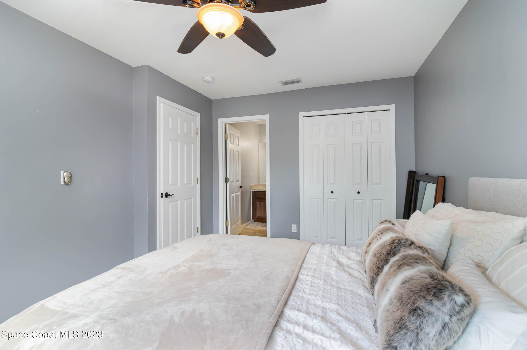 2805 Reston Street, Unit 103 Melbourne, FL 32935 - Photo 17 of 36 a bedroom with a bed and cabinets