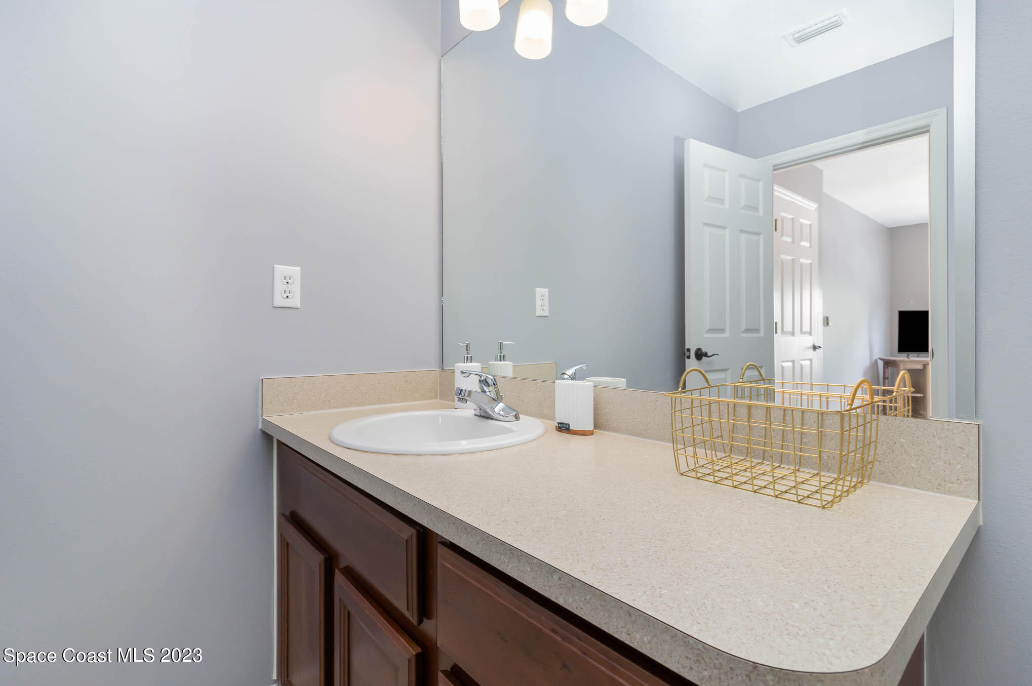 2805 Reston Street, Unit 103 Melbourne, FL 32935 - Photo 18 of 36 a bathroom with a sink and a mirror