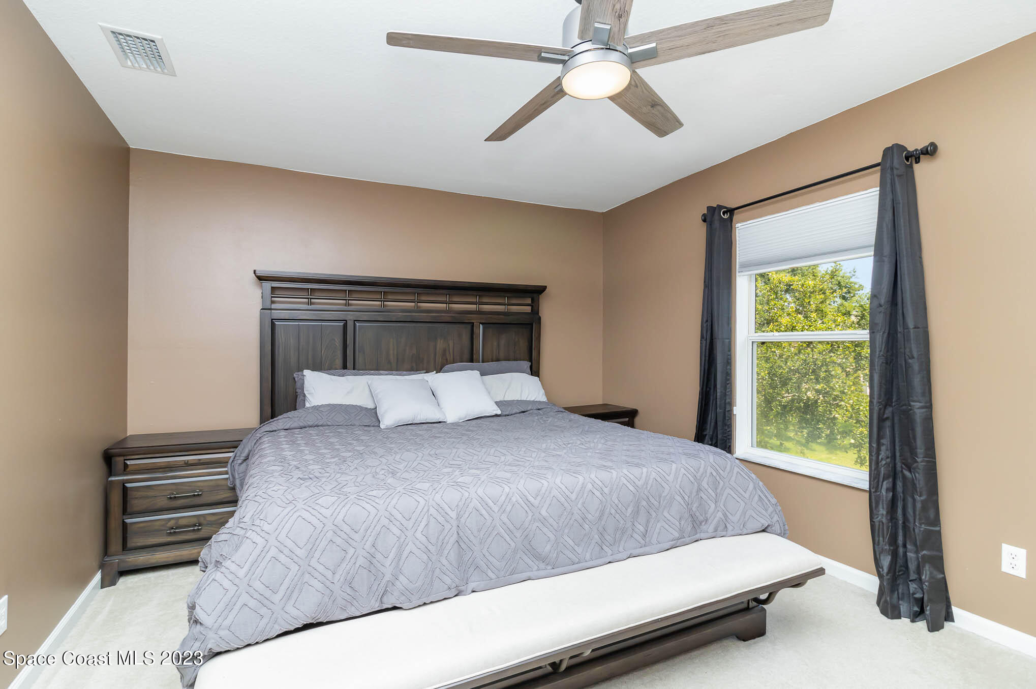 2805 Reston Street, Unit 103 Melbourne, FL 32935 - Photo 22 of 36 a bedroom with a large bed and a chandelier