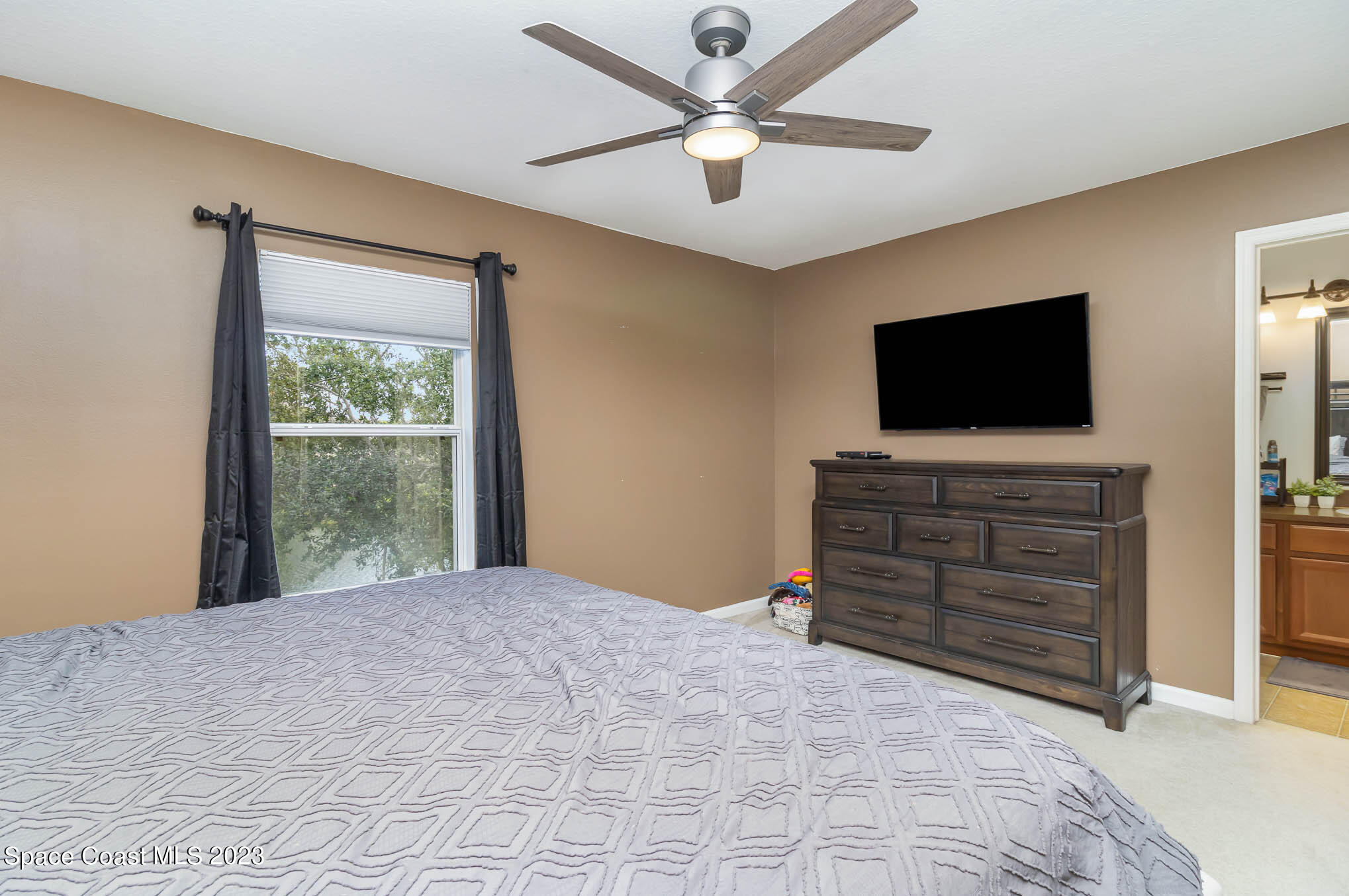 2805 Reston Street, Unit 103 Melbourne, FL 32935 - Photo 23 of 36 a bedroom with a bed and a flat screen tv