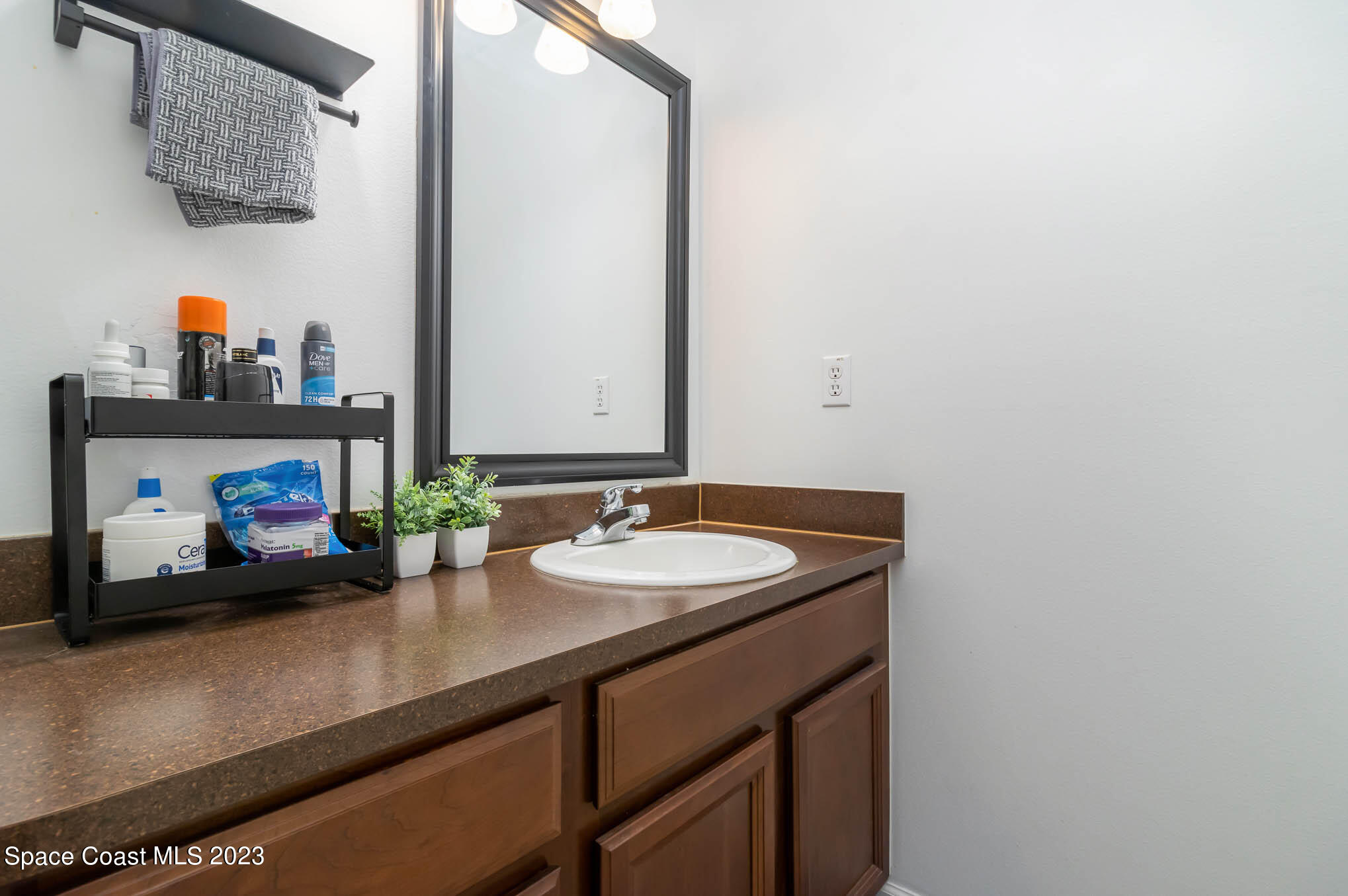 2805 Reston Street, Unit 103 Melbourne, FL 32935 - Photo 24 of 36 a bathroom with a sink and a mirror