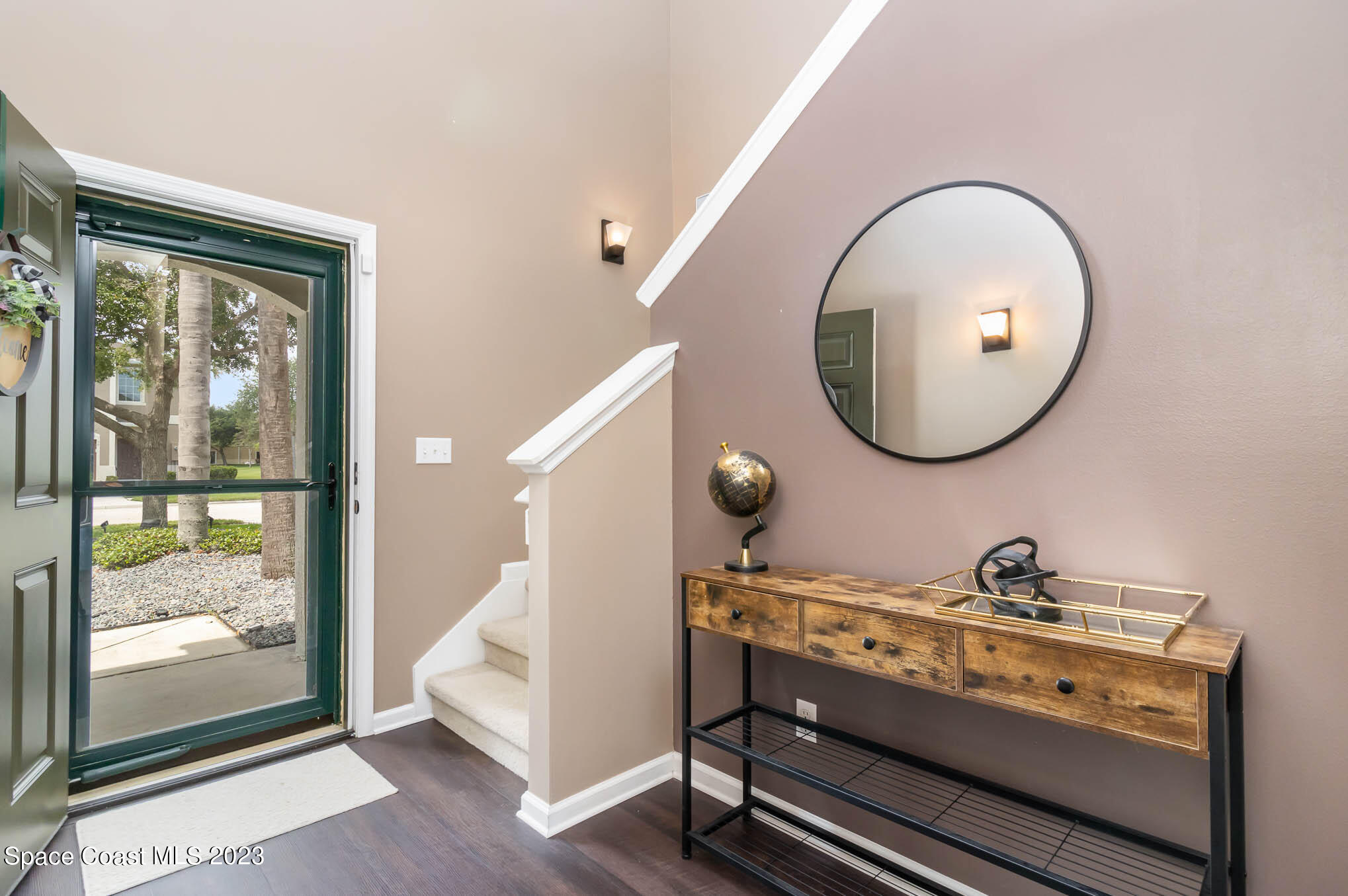 2805 Reston Street, Unit 103 Melbourne, FL 32935 - Photo 5 of 36 a room with a mirror and a lamp