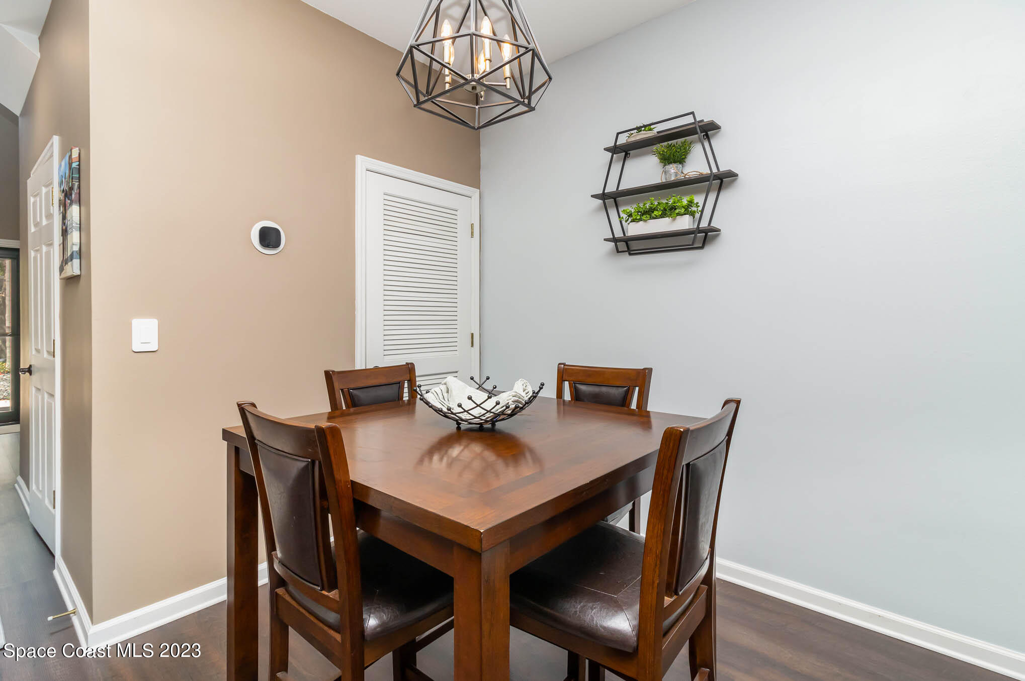 2805 Reston Street, Unit 103 Melbourne, FL 32935 - Photo 6 of 36 a view of a dining room with furniture and chandelier
