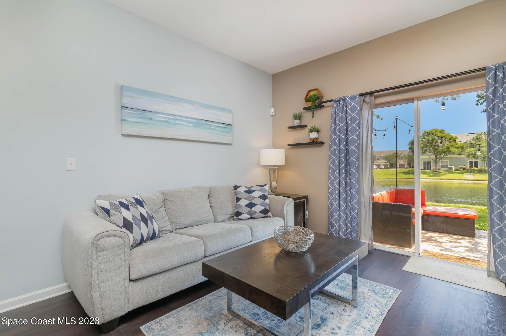 2805 Reston Street, Unit 103 Melbourne, FL 32935 - Photo 7 of 36 a living room with furniture and a floor to ceiling window