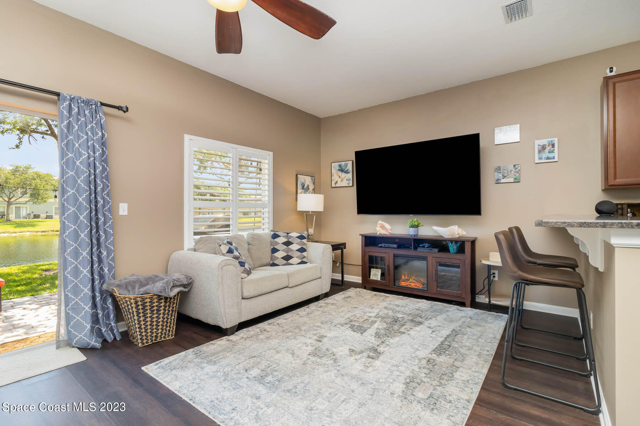 2805 Reston Street, Unit 103 Melbourne, FL 32935 - Photo 8 of 36 a living room with furniture and a flat screen tv