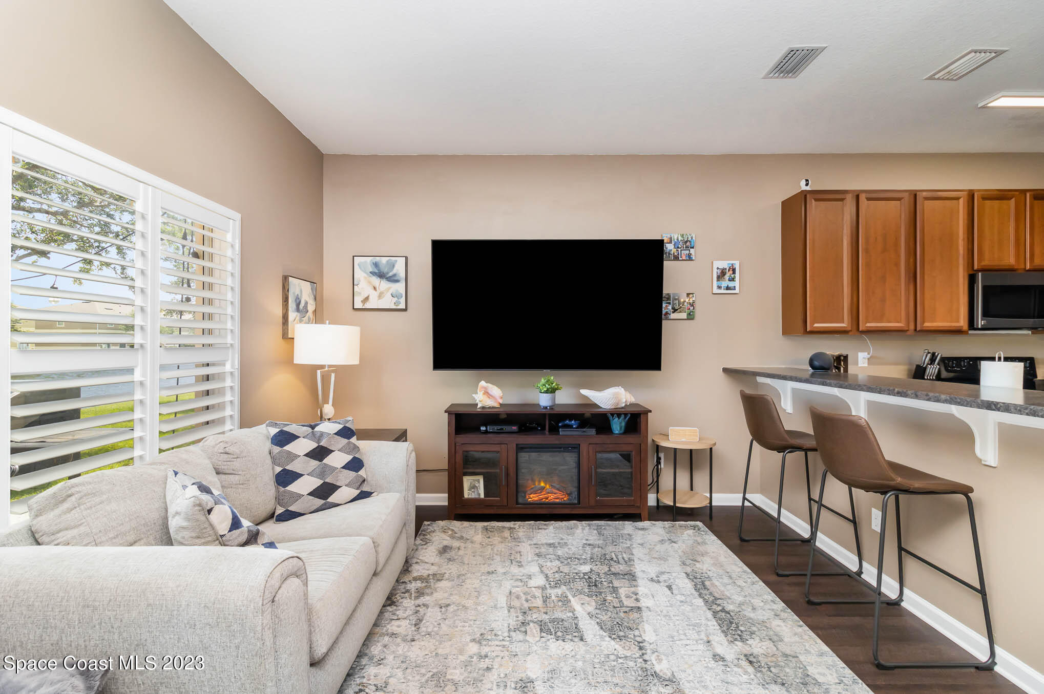 2805 Reston Street, Unit 103 Melbourne, FL 32935 - Photo 10 of 36 a living room with furniture and a flat screen tv