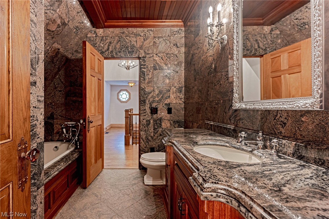 7265 Markell Road Waite Hill, OH 44094 - Photo 29 of 40 Bathroom with wood ceiling, toilet, crown molding, oversized vanity, and a bathtub