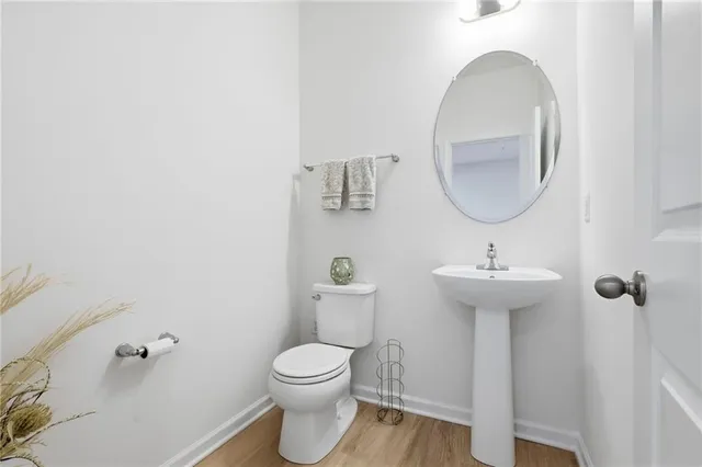 a view of a balcony with a couple of cars parked in front of house