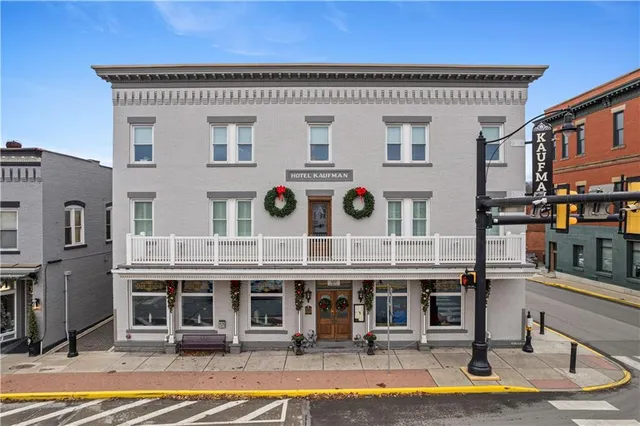 a front view of a house with sitting area