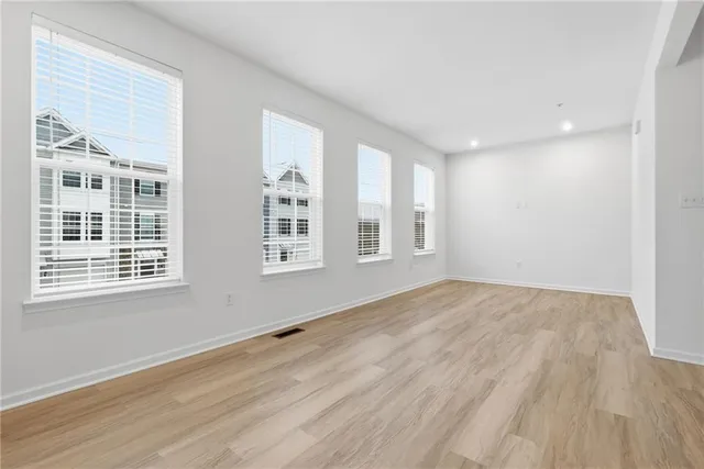 a view of a kitchen with refrigerator and a stove top oven