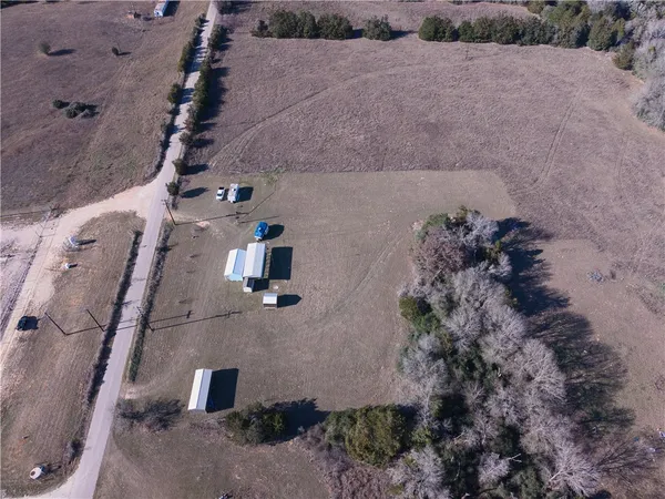 an aerial view of a house with a yard
