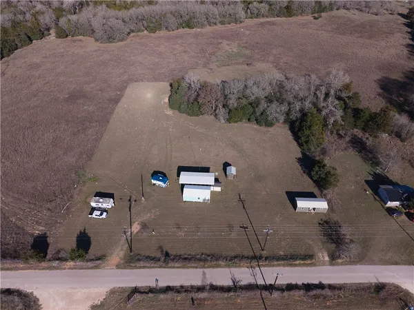an aerial view of a house with a yard